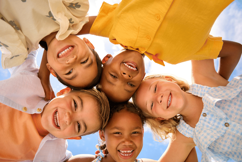 Teachers guiding children in a Reggio Emilia-inspired classroom using creative, child-centered learning methods.